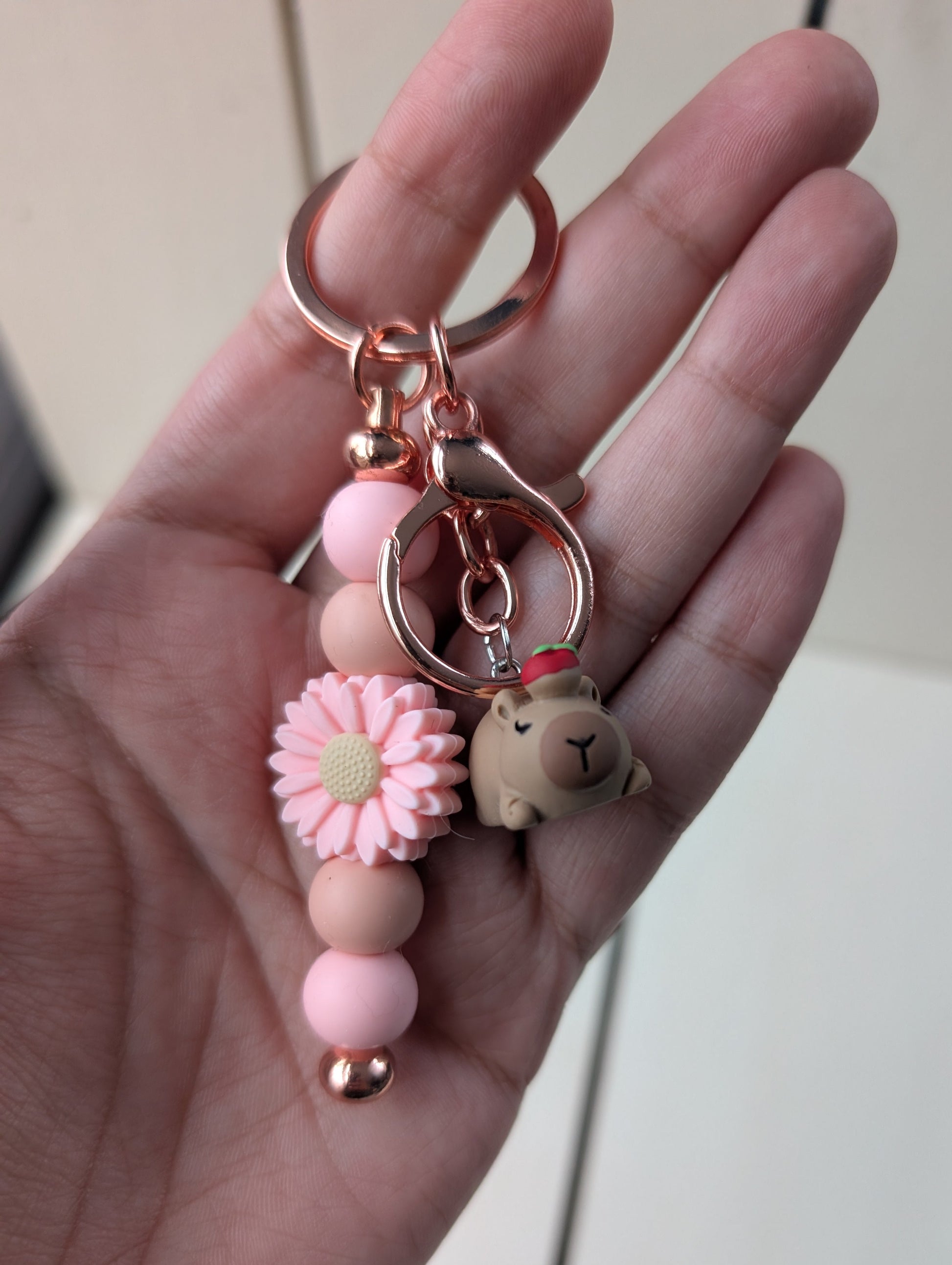 Bar keychain with flower silicone bead and resin capybara hanging charm.